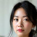 Akari Sato, lead design artist, sketching a car livery with a focused expression.